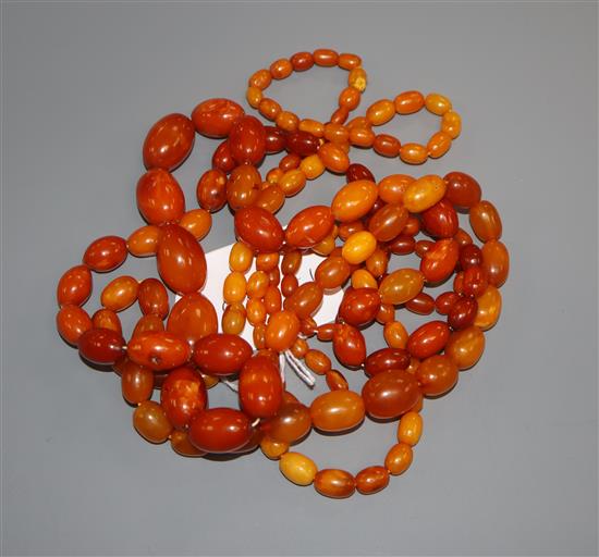 A single strand graduated amber bead necklaces and one other necklace containing amber and simulated amber beads,